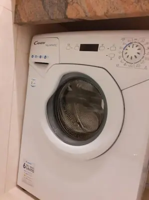 a washing machine with its door open in a room at Loft Apartment Old Town - G47 in Kraków