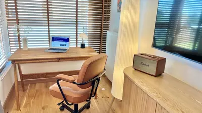 a desk with a laptop and a chair in a room at MintKrak in Kraków