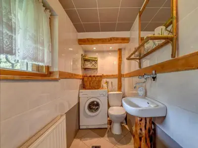 a small bathroom with a toilet and a sink at Klimatyczny domek w górach in Sordelówka