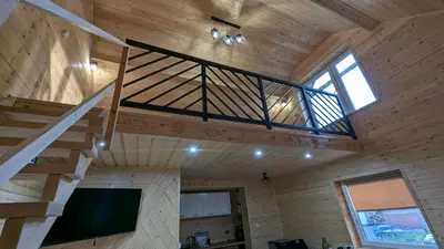 a wooden house with a staircase and a tv at Domek wypoczynkowy Górskie Zacisze II in Sidzina