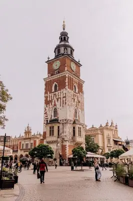 a tall tower with a clock on top of a building at Przytulny apartament w sercu Krakowa Old Town in Kraków