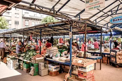 a produce market with people standing in front of it at Apartment in the Heart of Krakow - Between the Old Town and Kazimierz District in Kraków