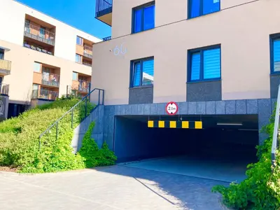 a parking garage in front of a building at Apartament Łagiewniki 2 in Kraków