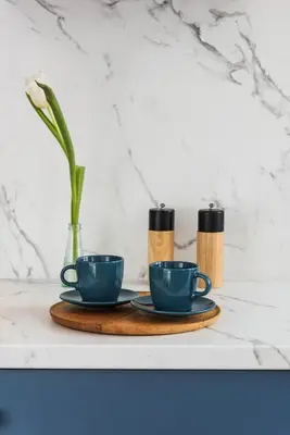 two coffee cups and a vase on a table at Silver Suite Old Town Apartament in Kraków