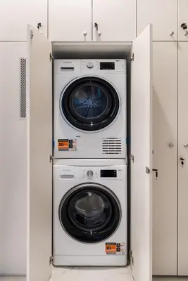 a washer and dryer in a white room at Silver Suite Old Town Apartament in Kraków