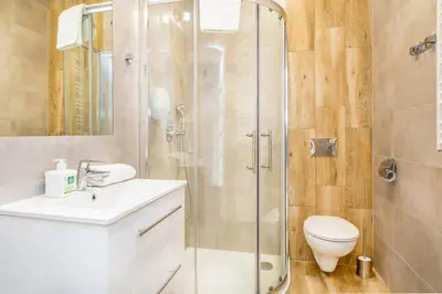 a bathroom with a shower and a toilet and a sink at Bosacka old town apt - B17 in Kraków
