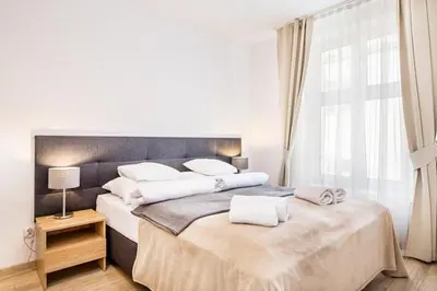 a bedroom with two beds with white towels on them at Bosacka old town apartment - B28 in Kraków