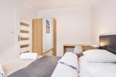 a bedroom with two beds with white pillows at Bosacka old town apartment - B28 in Kraków