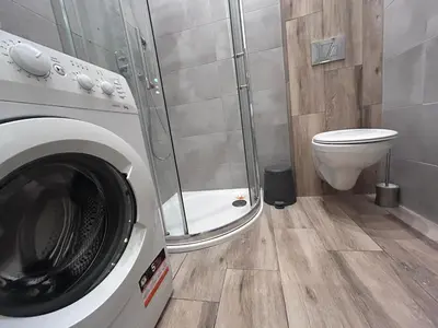 a bathroom with a washing machine and a toilet at Old Town Apt - Bosacka B30 in Kraków