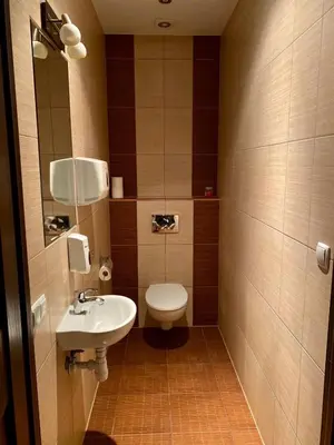 a small bathroom with a toilet and a sink at AMETYST Hostel in Kraków
