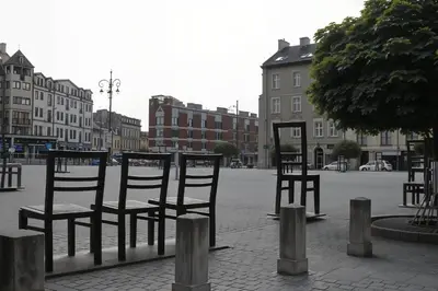 a group of chairs sitting in the middle of a street at Cracow Fancy Brick #4 - Old Town in Kraków