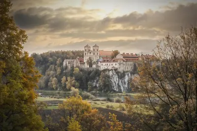 a castle on top of a hill with trees at Cracow Copernican Apartment #2 - Old Town in Kraków