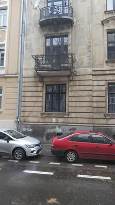two cars parked in front of a building at Cracow Route #3 - Old Town in Kraków