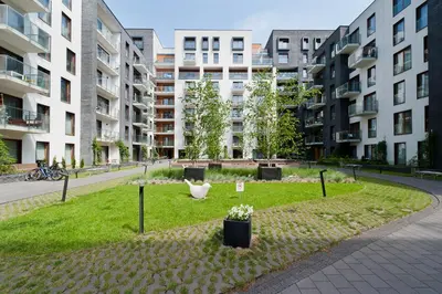 a park in a city with tall buildings at ApartmentPrestige Premium in Kraków