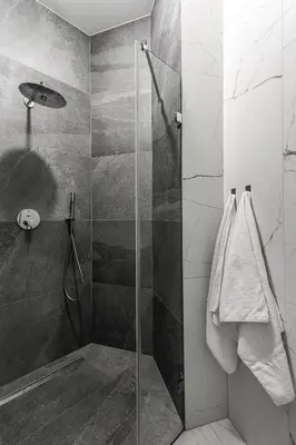 a shower with a glass door in a bathroom at Kossak Residence - by Wawel Castle in Kraków