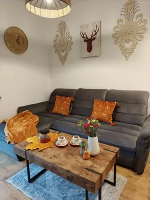 a living room with a couch and a coffee table at MICHAŁÓWKA - Domek w Górach przy Lesie - Energylandia in Targanice