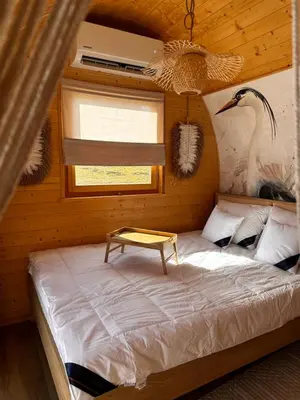 a bedroom with a bed with a table on it at Raj na Hektarach in Limanowa