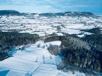 an aerial view of a ski slope in the snow at Raj na Hektarach in Limanowa