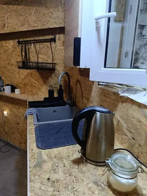 a kitchen counter with a tea kettle and a sink at Kapsuła #2 Centrum in Kraków