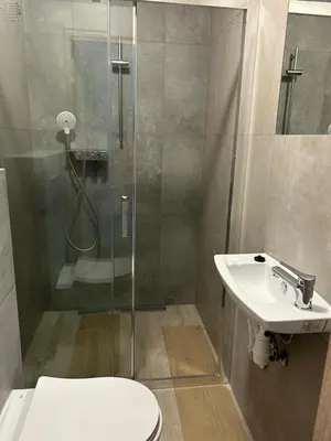 a bathroom with a shower and a toilet and a sink at Lawendlove in Kraków