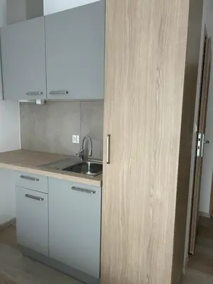 a kitchen with white cabinets and a sink at Lawendlove in Kraków