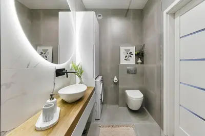 a bathroom with a sink and a toilet and a mirror at Cosy Blue Cracow Apartment in Kraków