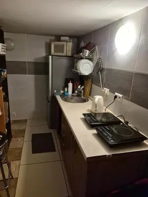 a small kitchen with a sink and a refrigerator at Pokoj u Eleni #2 in Kraków
