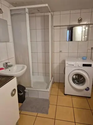 a bathroom with a washing machine and a sink at Pokoj u Eleni #3 in Kraków