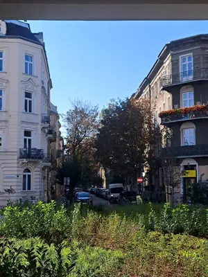a street with cars parked on the side of the road at Apartament Bonerowska Blue in Kraków