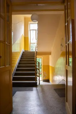 a staircase in a house with yellow walls at Old Town Gateway in Kraków