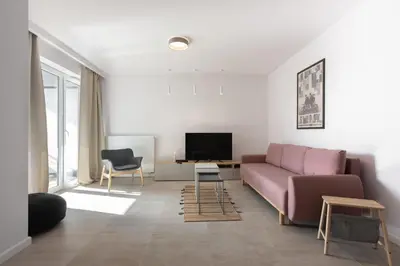 a living room with a couch and a tv at Przestronny apartament PARKING by NEARTOpl in Kraków