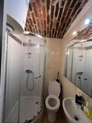 a bathroom with a shower and a toilet and a sink at Kawalerka,studio underground in Kraków
