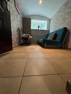 a living room with a couch and a window at Kawalerka,studio underground in Kraków