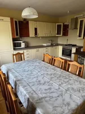 a kitchen with a table with chairs and a counter top at Bochnia,kwatery pracownicze,duży dom, noclegi in Bochnia