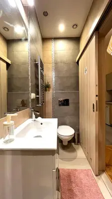 a bathroom with a white sink and a toilet at Studio in Kraków Center in Kraków