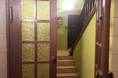 a hallway with a door and a stairway with stairs at Old Town Apt - Lubicz 2b in Kraków