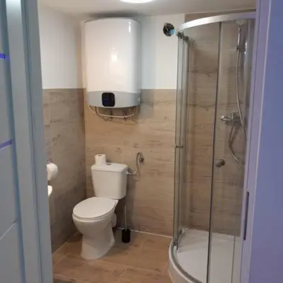 a bathroom with a toilet and a glass shower at Domek Krukk blisko Energylandii Zator in Zator