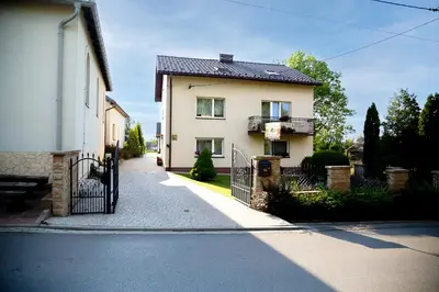 a house with a gate on the side of a street at Jurajska47 - trójka in Wola Kalinowska