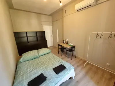 a bedroom with a bed and a table with a desk at Fantastic-Inn Kraków - KR63 in Kraków