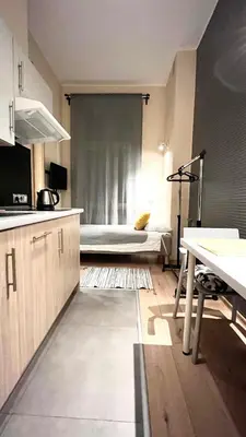 a kitchen with a bed in a room at Studio for One in Kraków