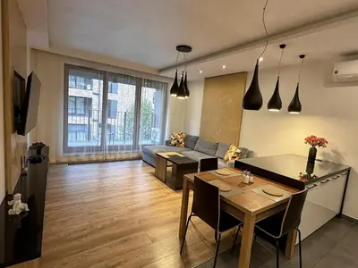 a living room with a table and a couch at Lubicz Apartment 70m2 in Kraków