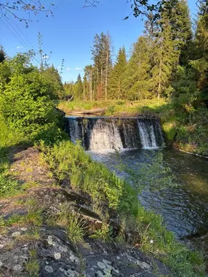 a waterfall in a field next to a river at Apartament w Kocierzu in Kocierz Rychwałdzki