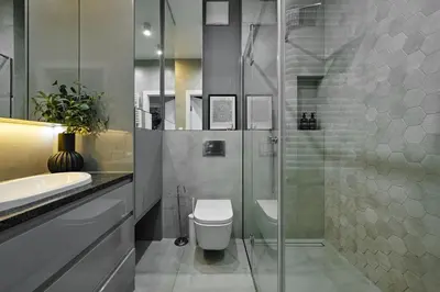 a bathroom with a toilet and a glass shower at City Dreams Apartment in Kraków