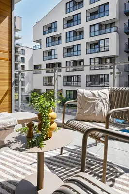 a balcony with a couch and a table and a building at Velvet Dreams Apartments 46 in Kraków