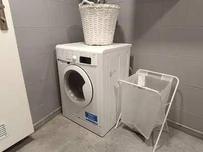 a washing machine with a basket on top of it at Pokój kapsułowy 7 in Kraków