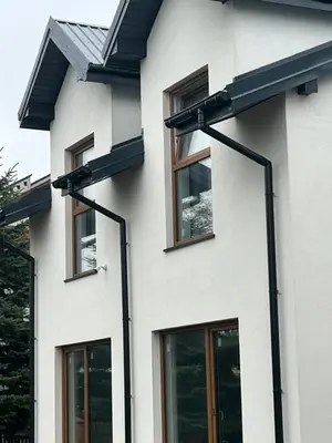 a white house with black windows on it at Mieszkanie na Lawendowej in Kraków