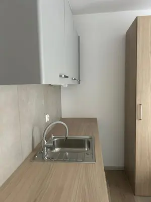 a kitchen with a sink and a wooden counter at Mieszkanie na Lawendowej in Kraków