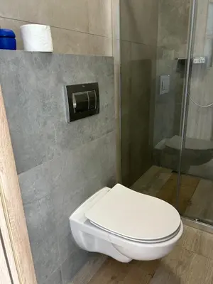 a bathroom with a toilet and a shower at Mieszkanie na Lawendowej in Kraków