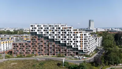 an apartment building with a pyramid facade in a city at Crystal Luxury Apartments Rakowicka in Kraków