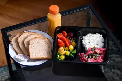 a tray of food with a plate of bread and vegetables at Native Apartments Kościuszki 39I14 in Kraków